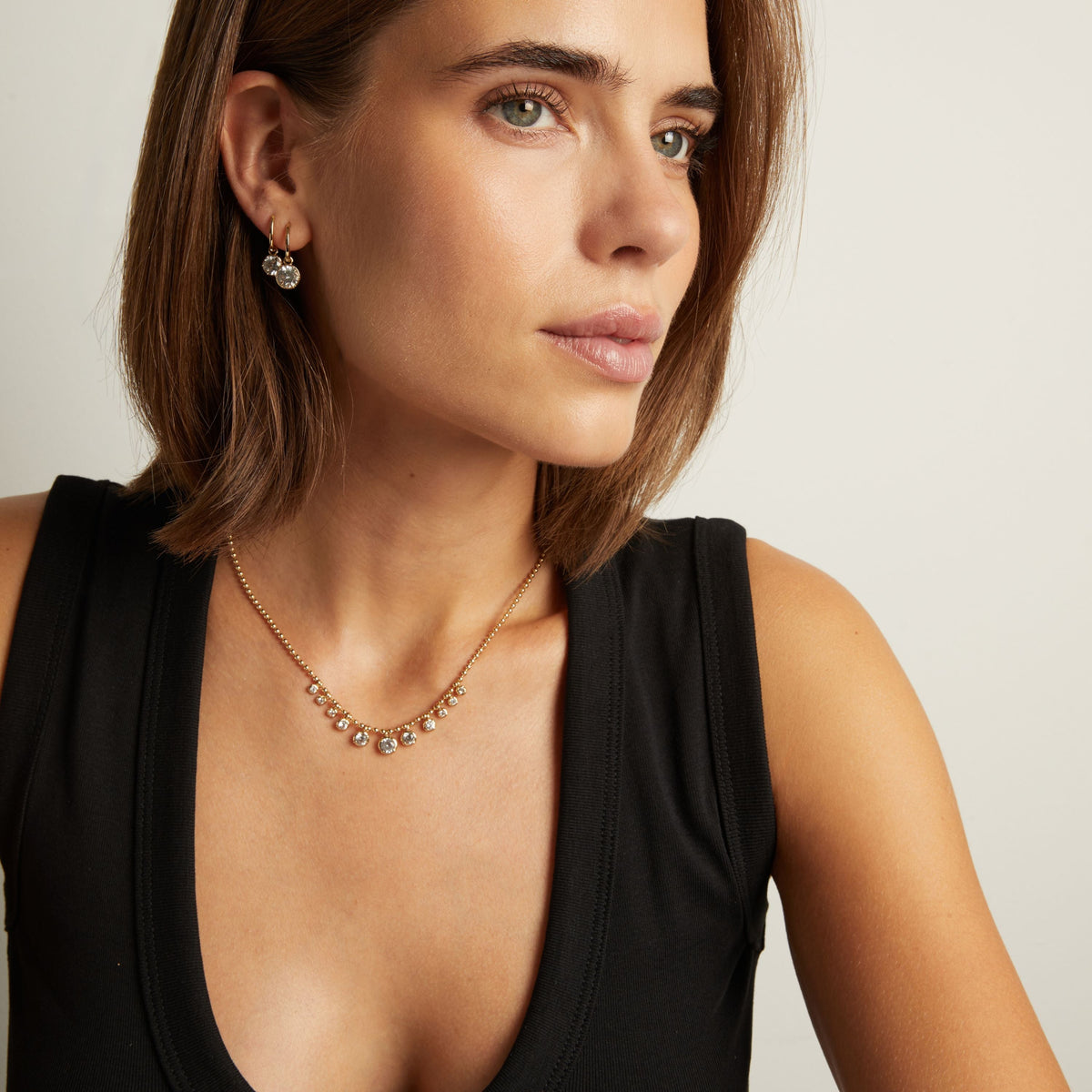 Model. Close up of woman wearing a Graduated Georgian Chain Necklace on neutral background.