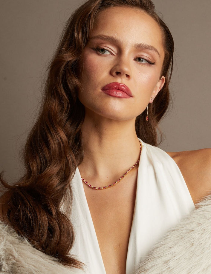 Model. Woman wearing a white top and fur coat with a neutral background
