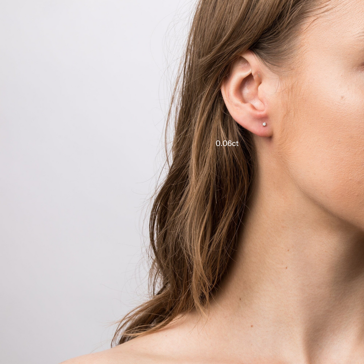 Model close up of woman wear diamond stud earring