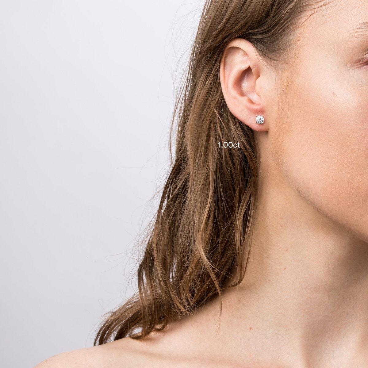 Model close up of woman wear diamond stud earring