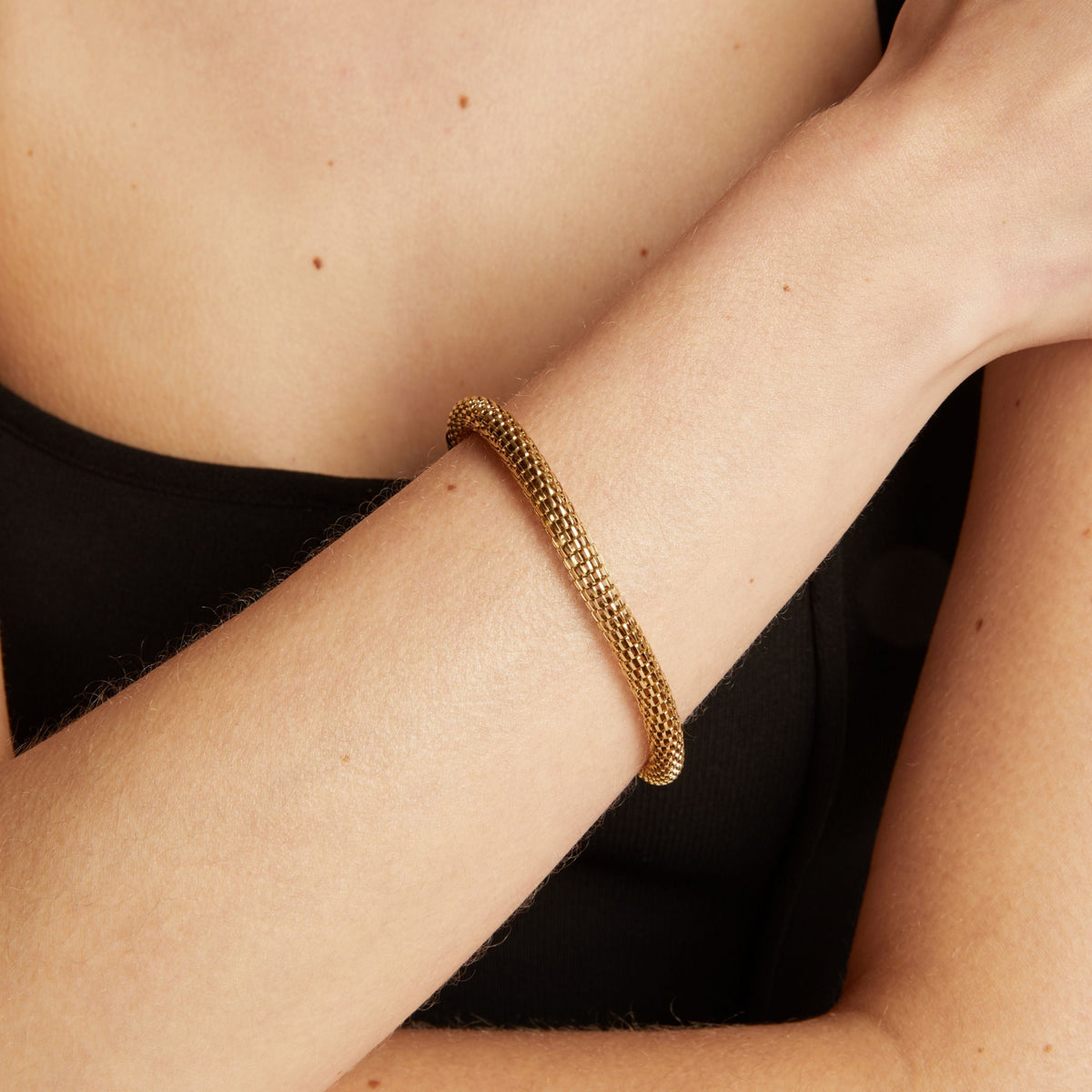 Gold chain bracelet on wrist. Model
