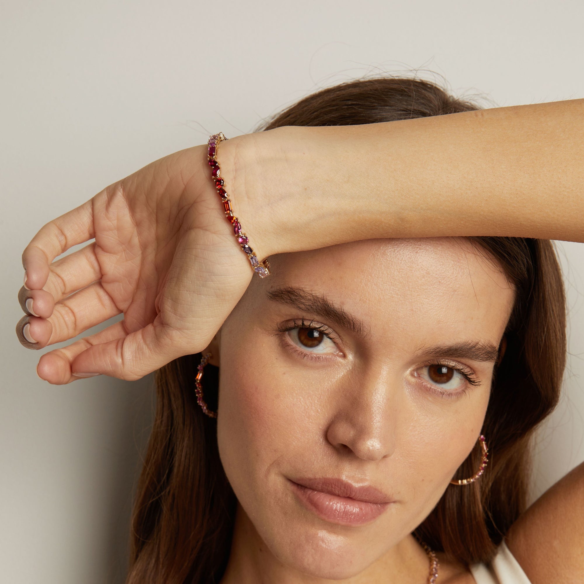 Model. Woman wearing a beaded bracelet on her wrist with a neutral background