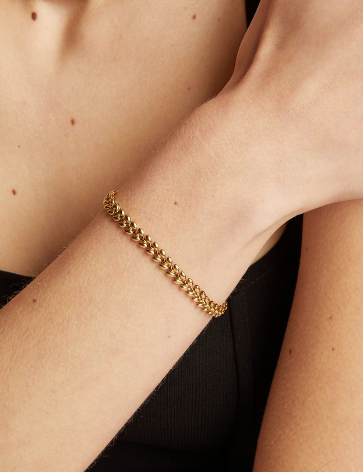 Gold chain bracelet on a person