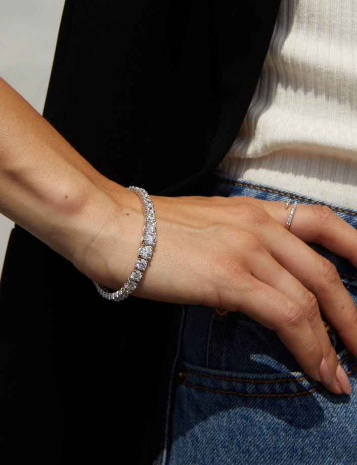 Model close up of woman wearing diamond bracelet and ring 