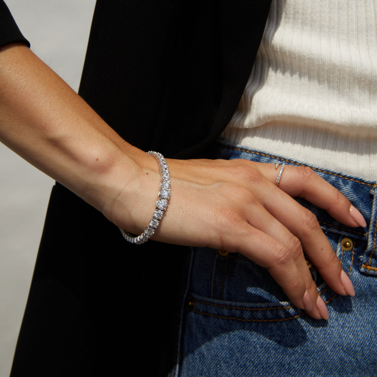 Model close up of woman wearing diamond bracelet and ring 