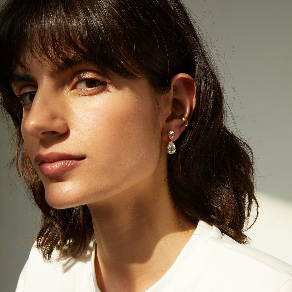 Lifestyle Model side profile of woman wearing diamond teardrop earring 