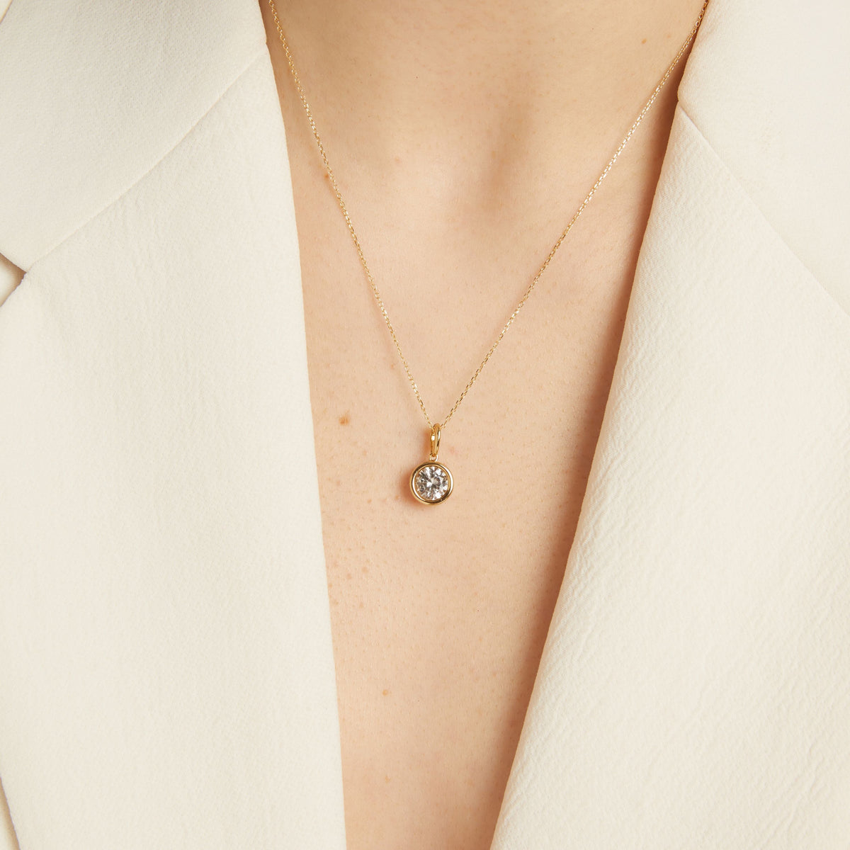 Round bezel diamond pendant on dainty necklace 