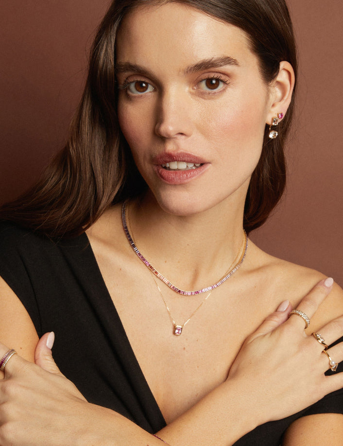 Model. Woman wearing jewelry with a brown background