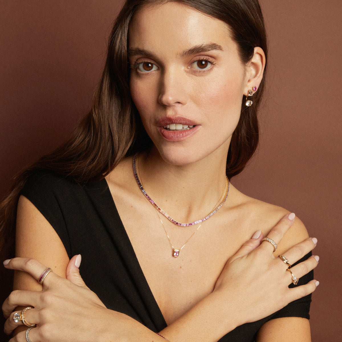 Model. Woman wearing jewelry with a brown background