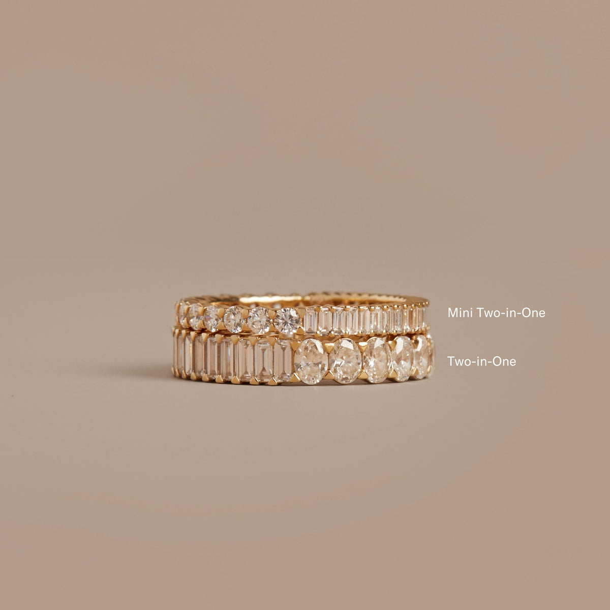 Model. Two gold rings with diamond accents on a beige background