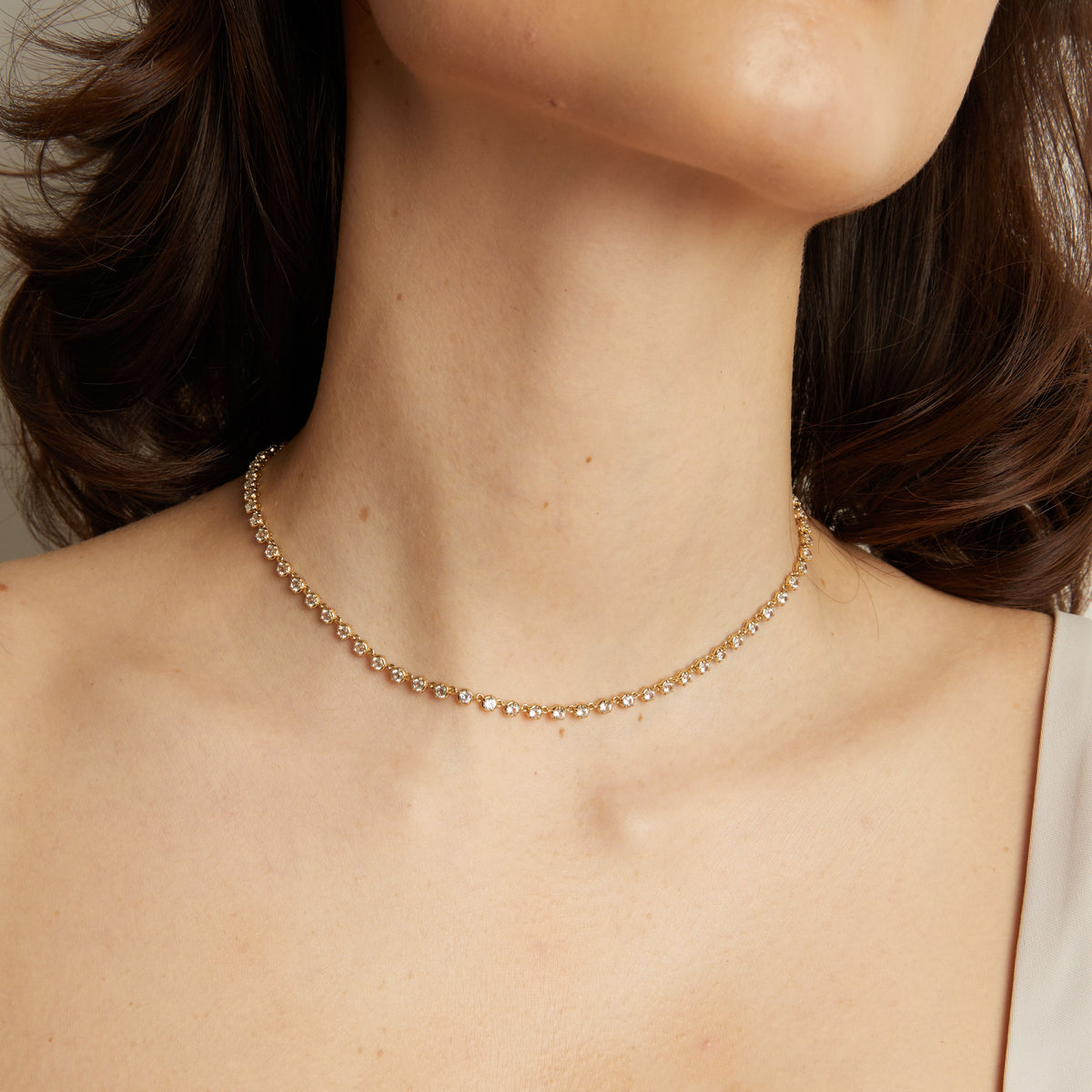 Model Gold necklace on a person with a neutral background