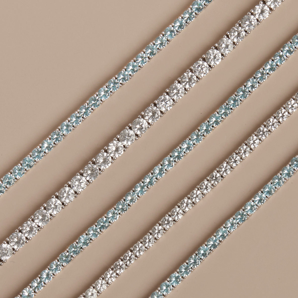 Model. Close-up tennis bracelets on a beige background