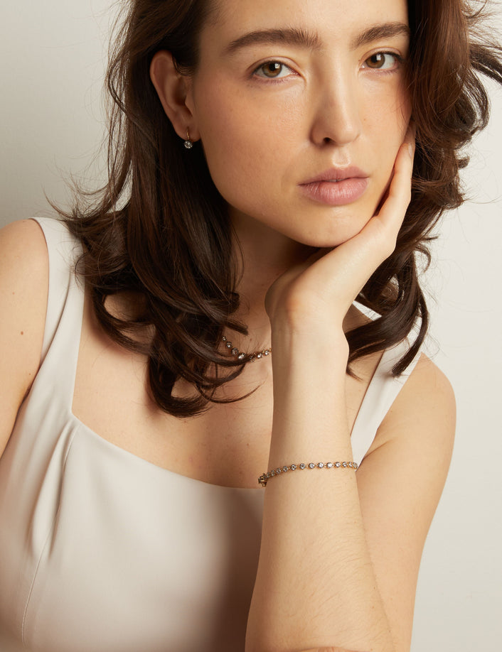 Model Woman with hand on chin against a plain background