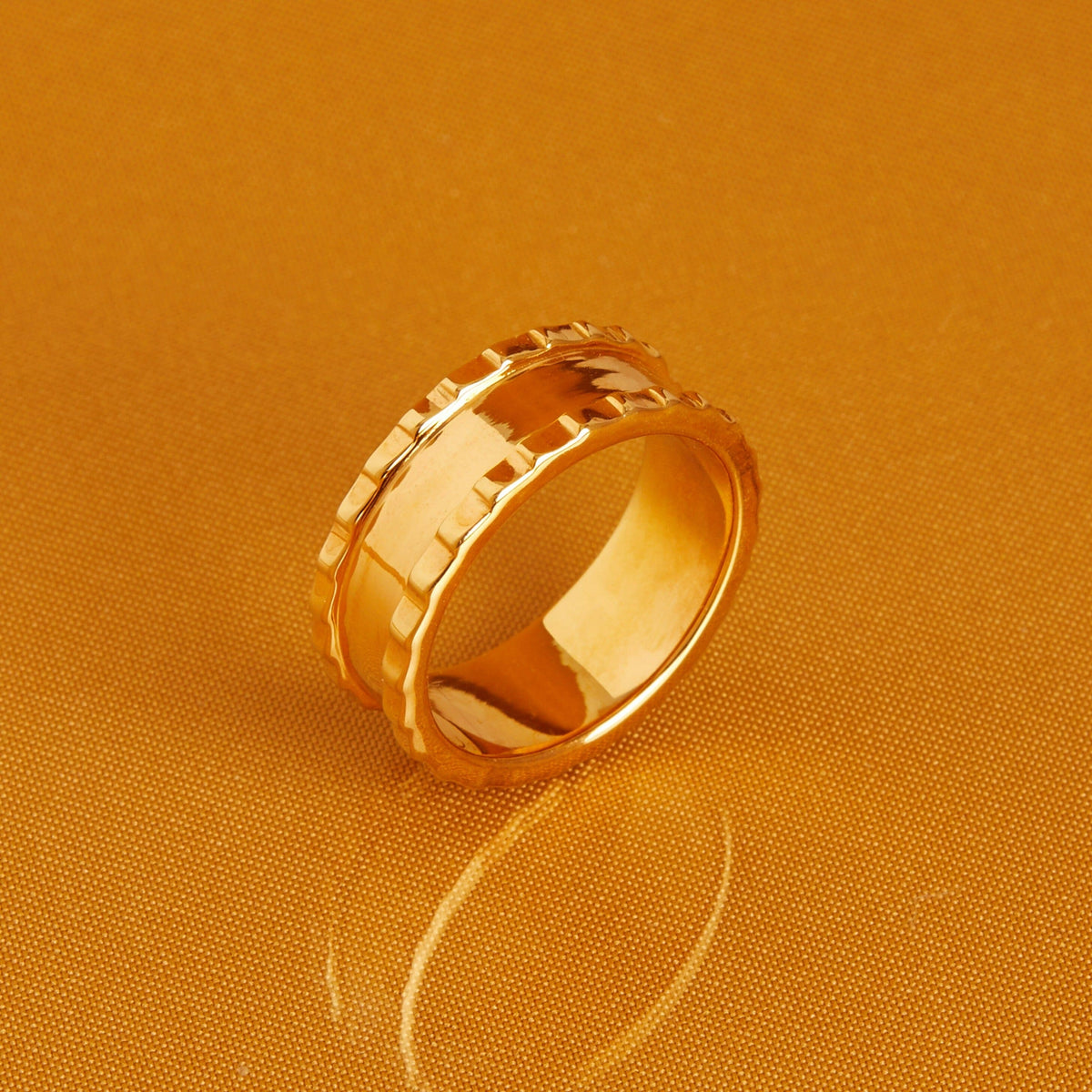 Flatlay Model. Thick gold ring on orange background