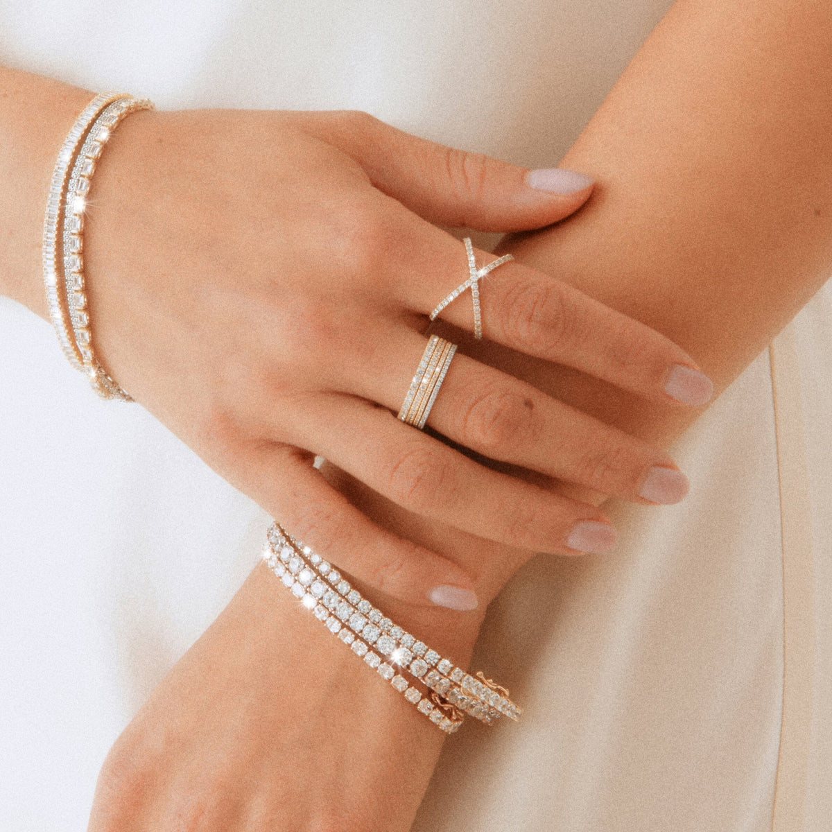 Lifestyle Model woman wearing various diamond jewelry on fingers and wrists 