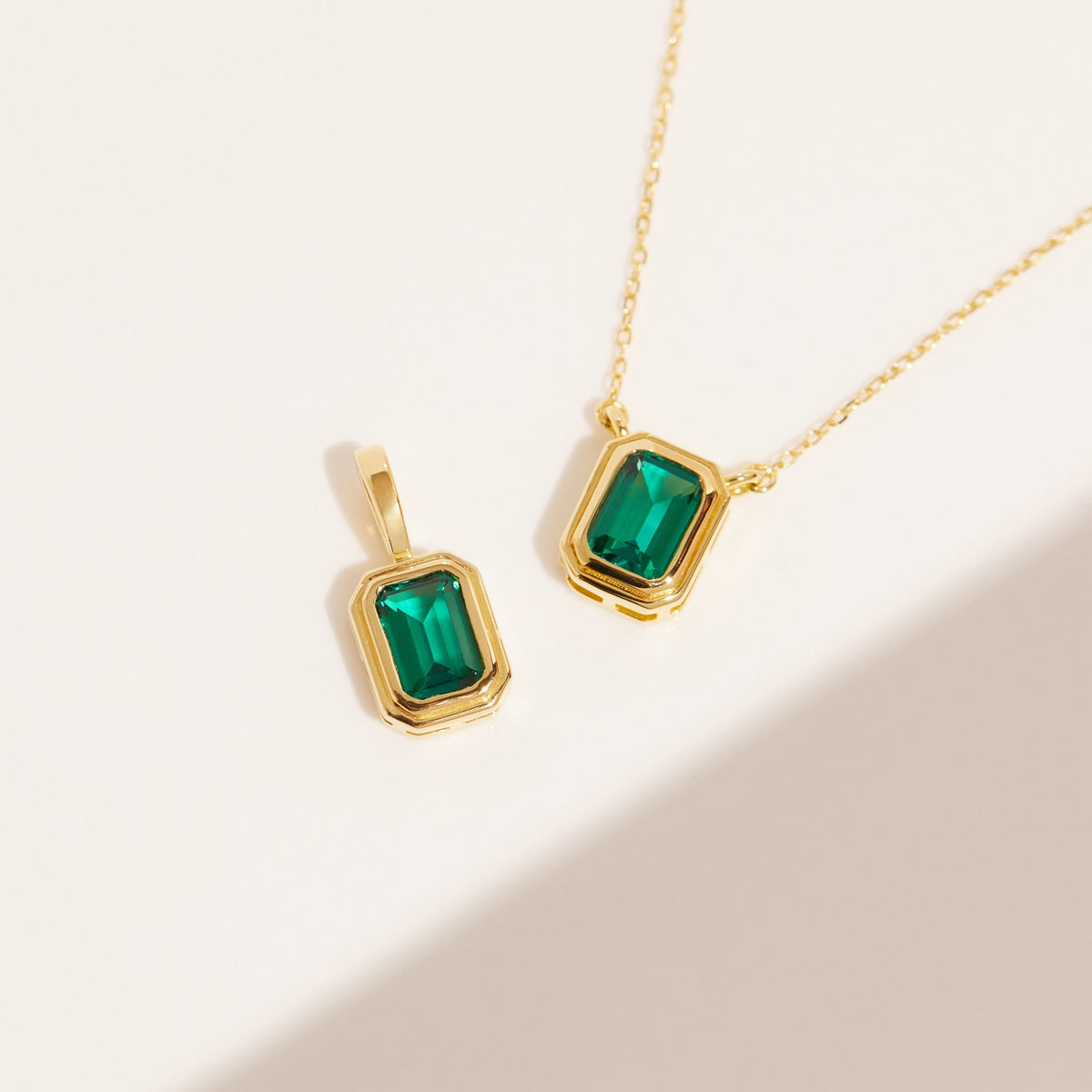 Flatlay Model two green gemstone necklaces on a white surface 