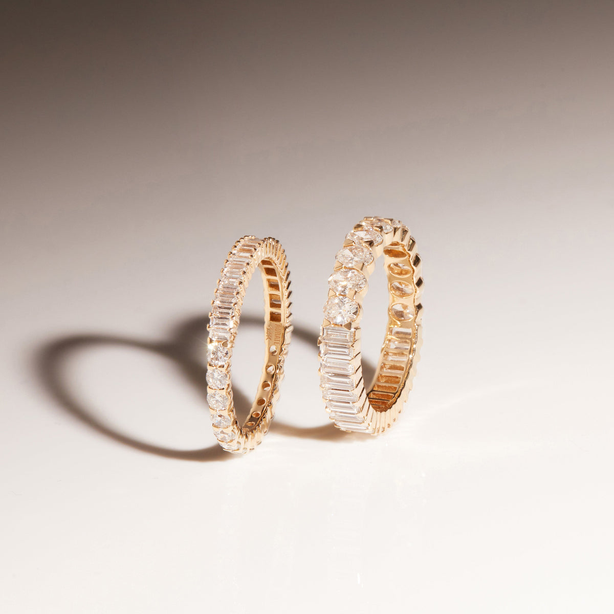 Flatlay Model two diamond and gold rings on a white background 