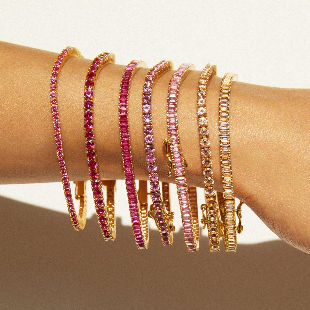 Model woman wearing different color tennis bracelets close up 