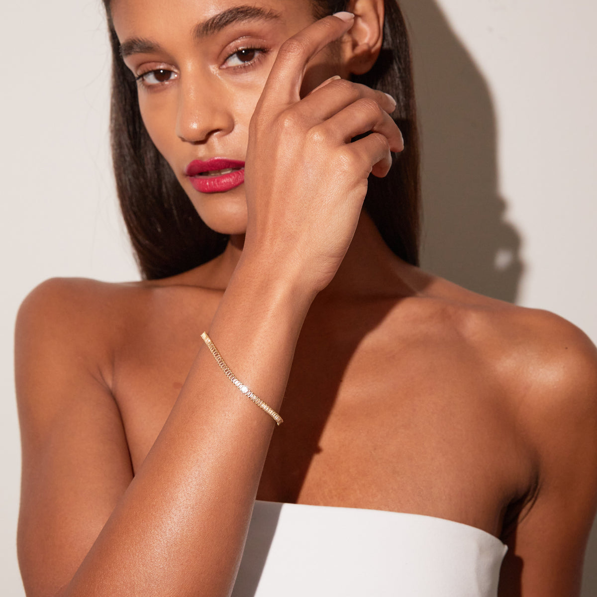 Model. Woman wearing a pink tennis bracelet 