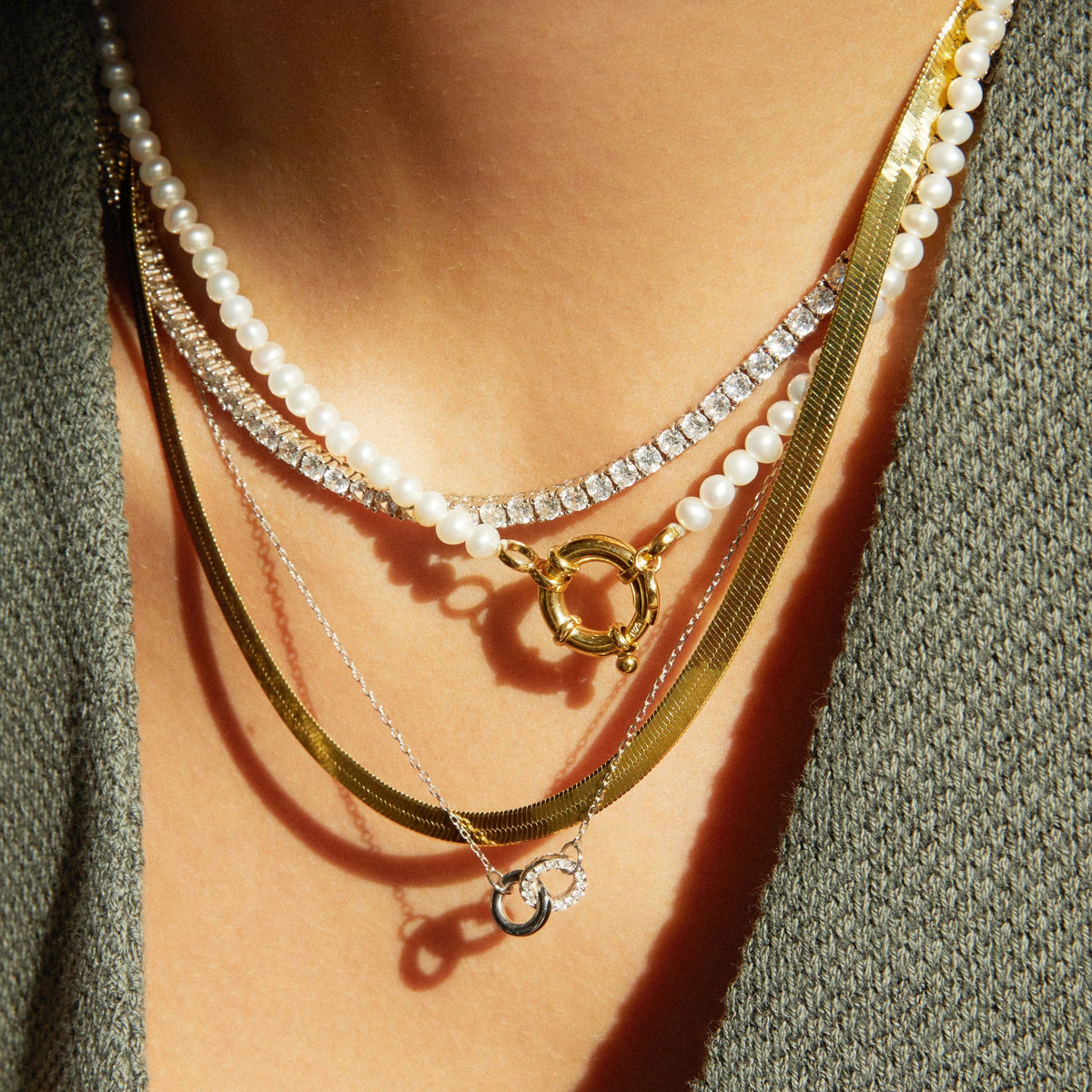 Model. Close up of woman wearing various necklaces