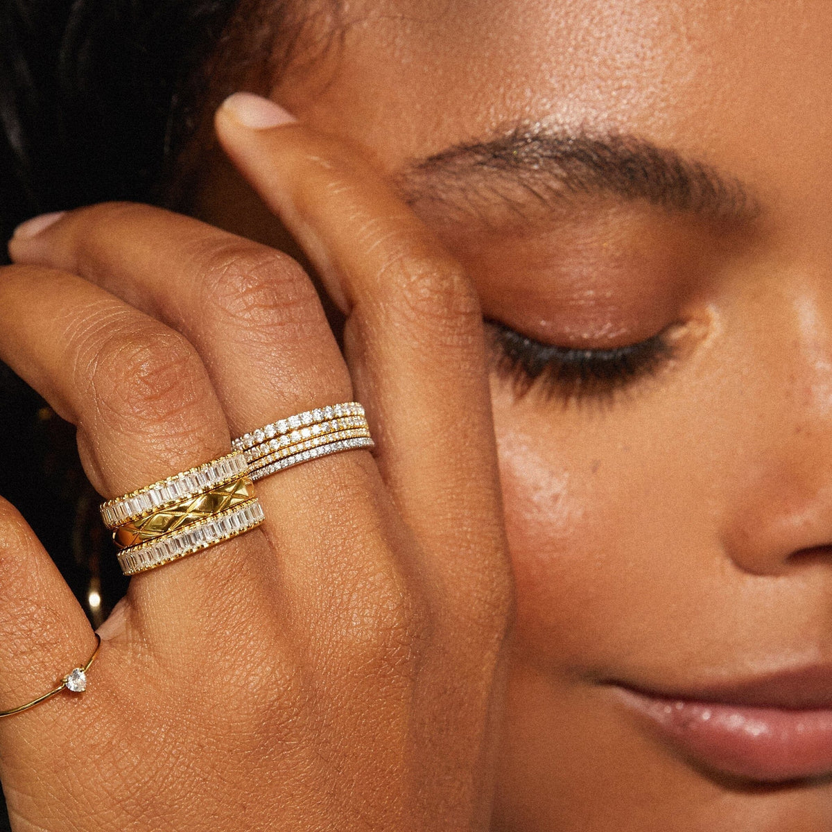 Lifestyle Model close up of woman wearing multiple gold rings 