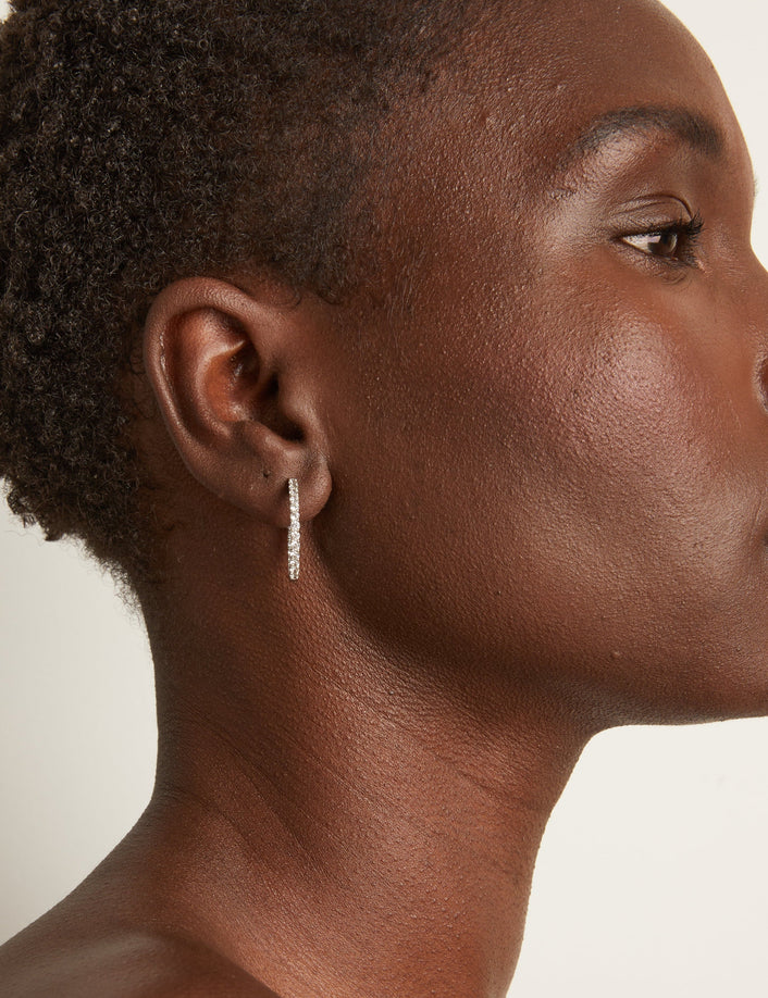 Woman wearing diamond hoop earrings