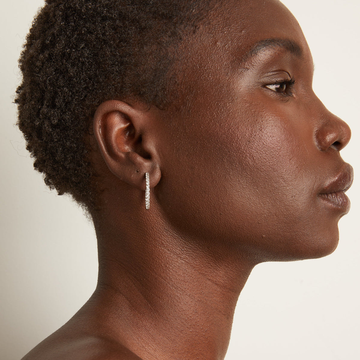 Woman wearing diamond hoop earrings