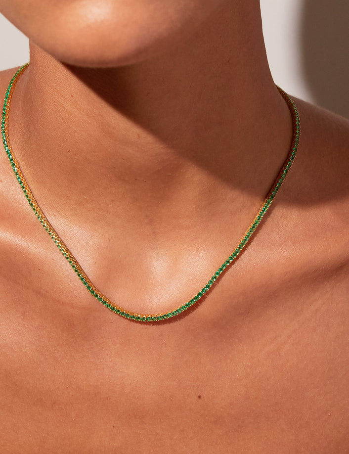 Model close up of woman wearing green stone necklace 