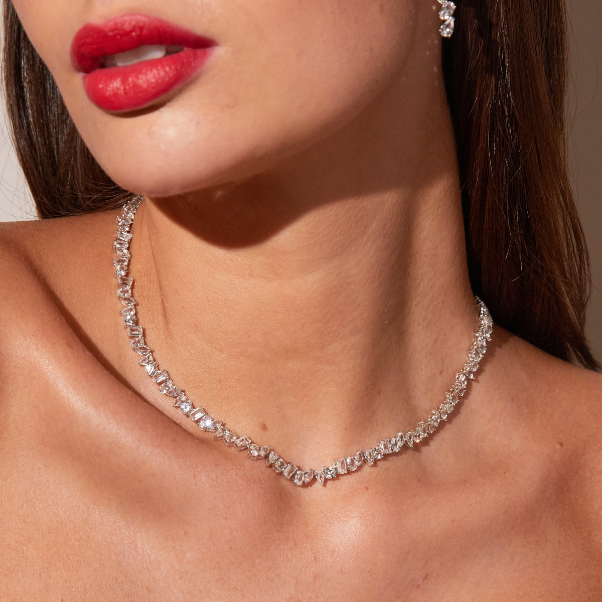 Close up of woman wearing tennis necklace with unique shape