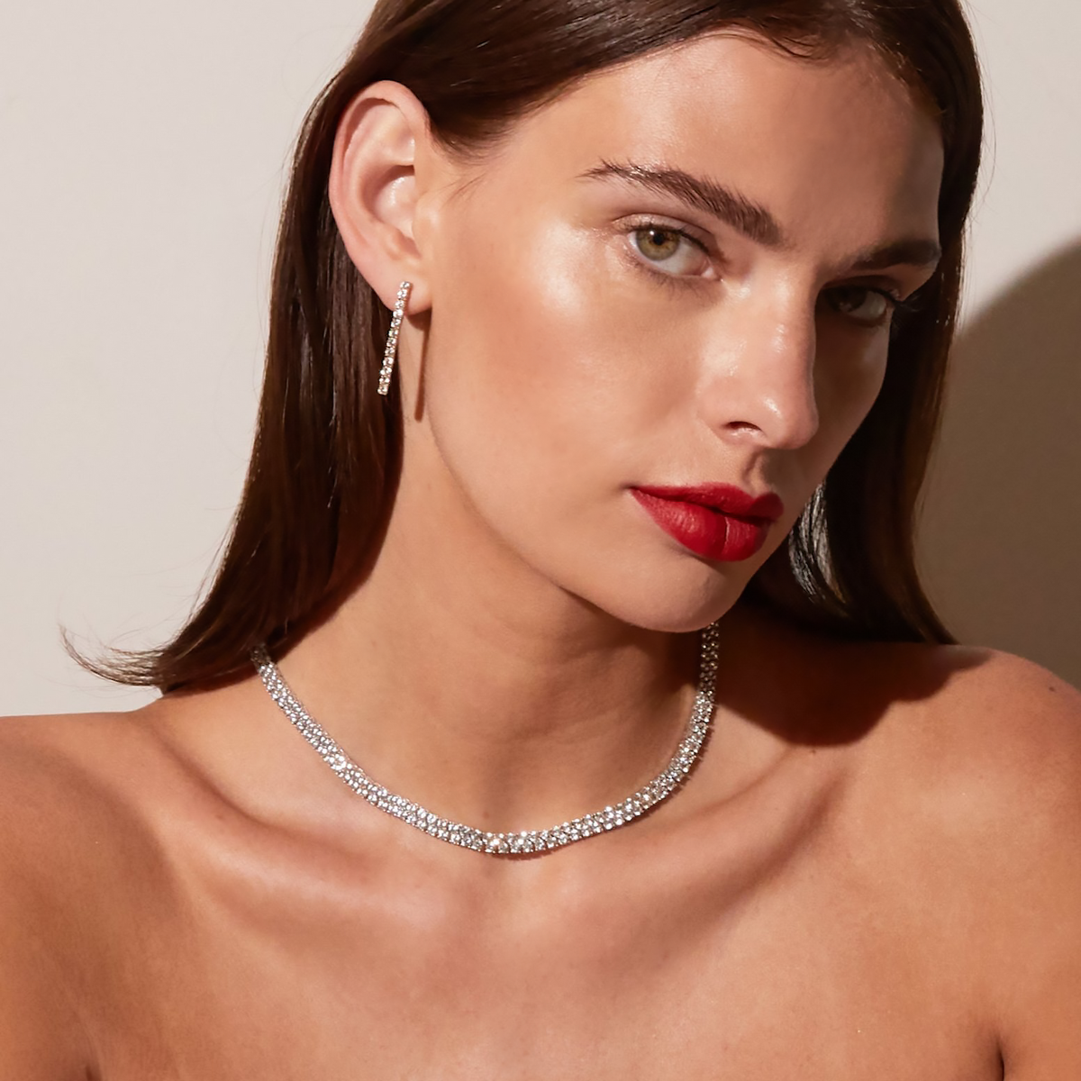 Model. woman wearing diamond necklace and erring 