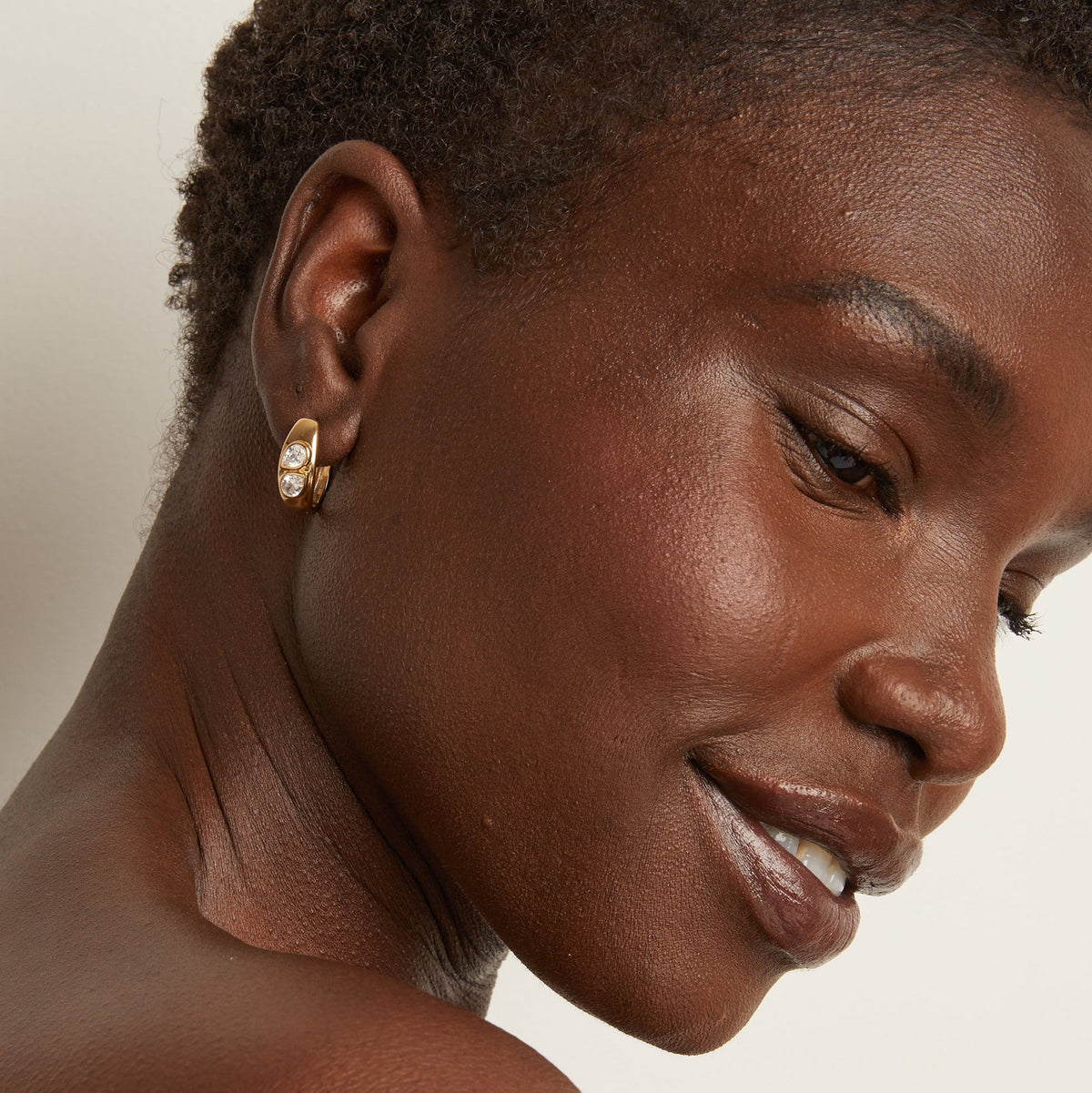 Model. Woman wearing gold earring 