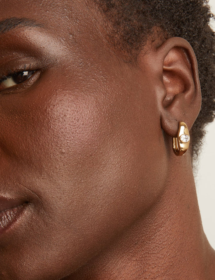 Woman wearing gold earring 