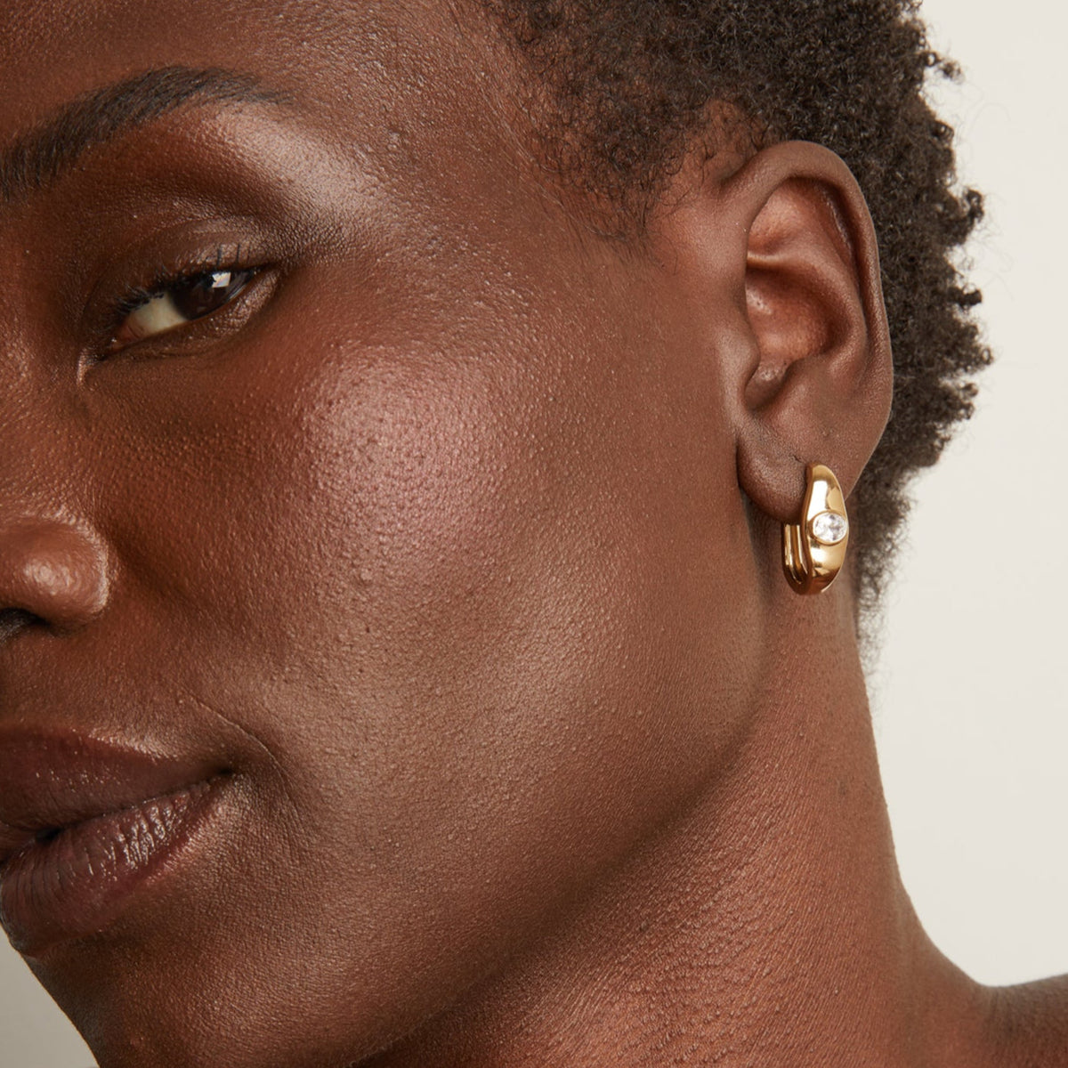 Woman wearing gold earring 