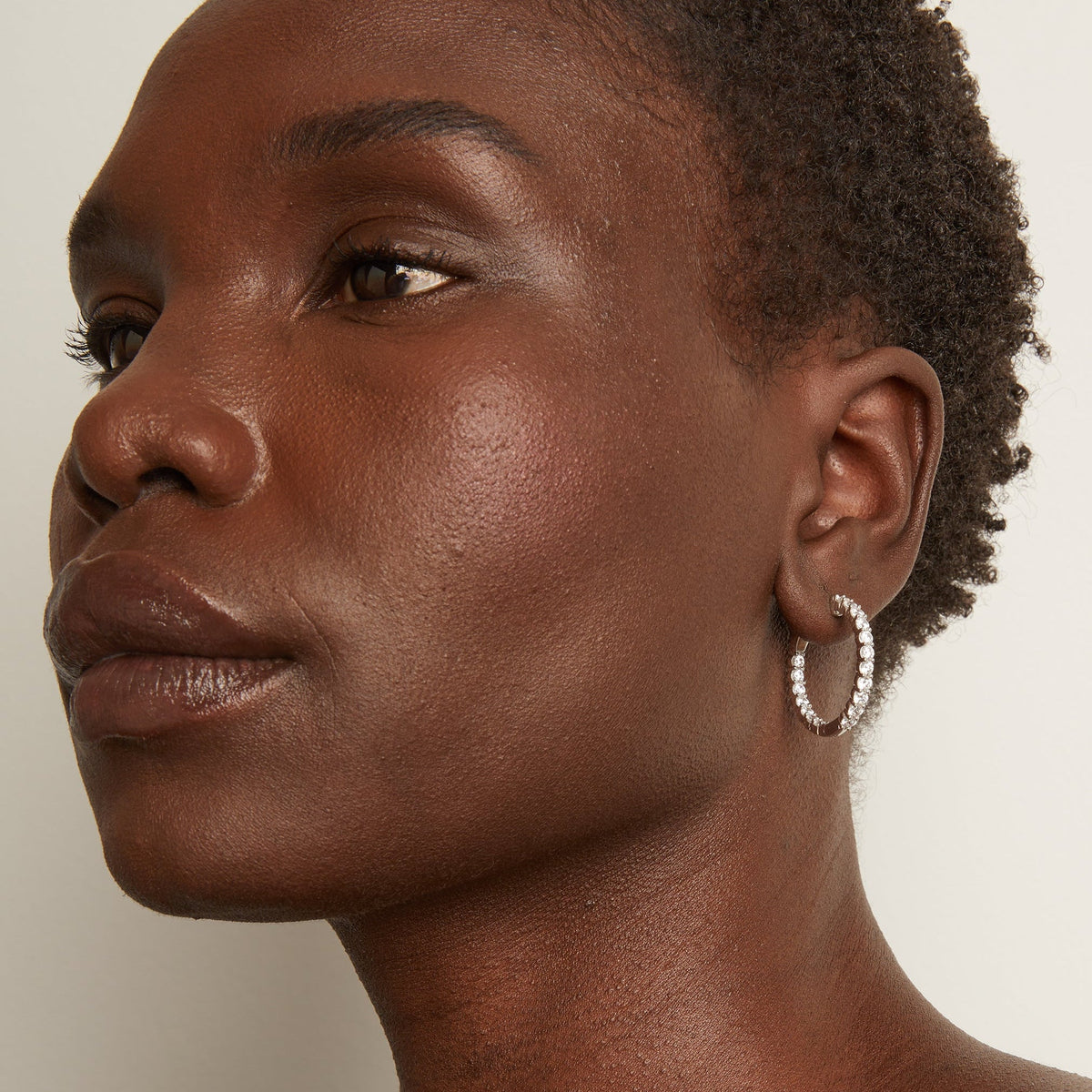 Woman wearing diamond hoop earrings