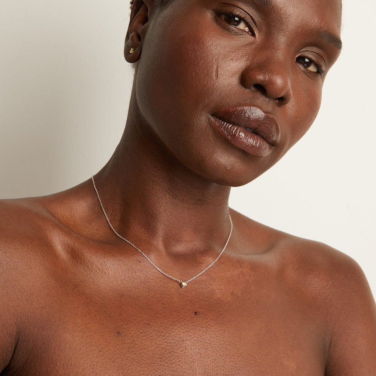 Model. Woman wearing delicate chain necklace.  