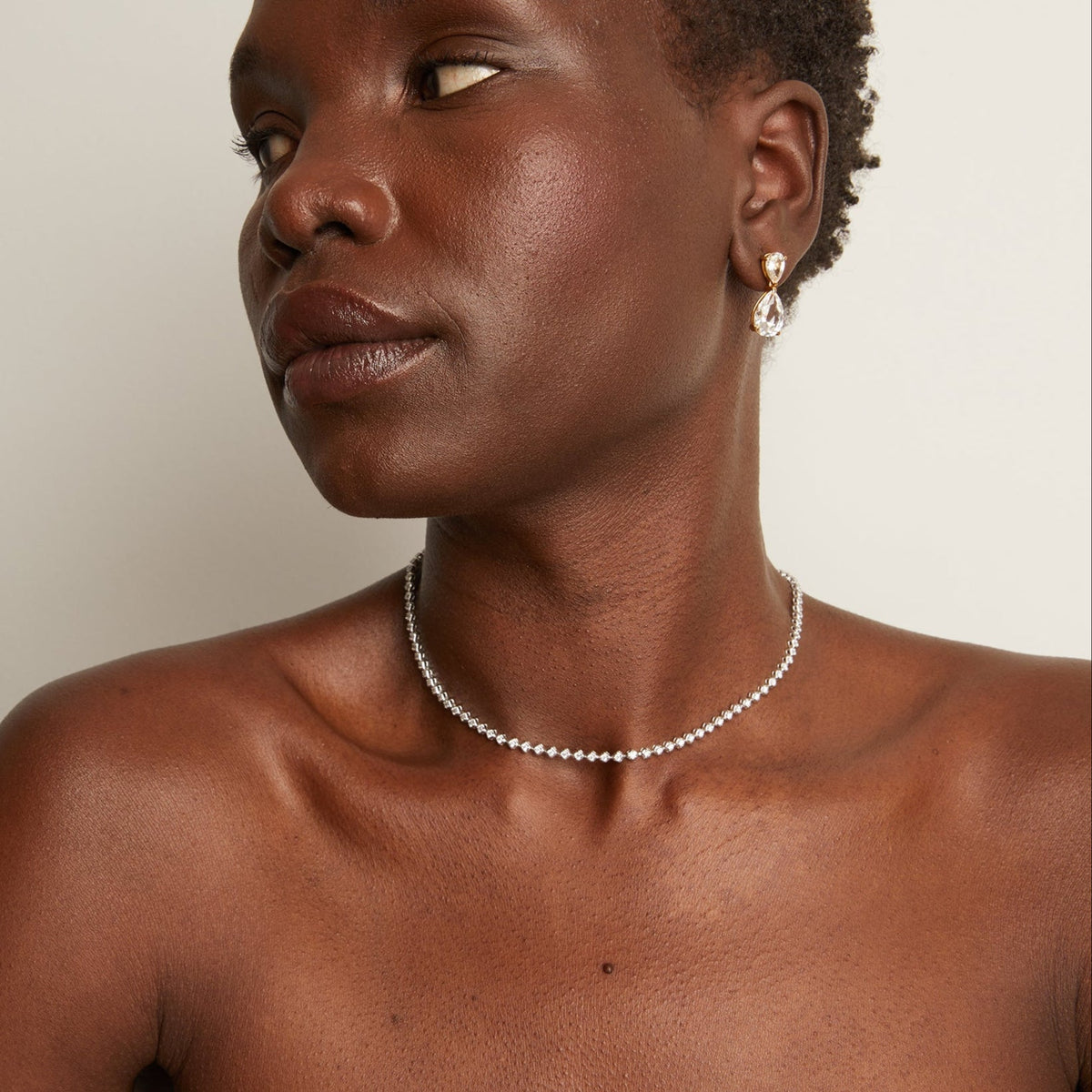 Model. woman wearing thin diamond necklace 