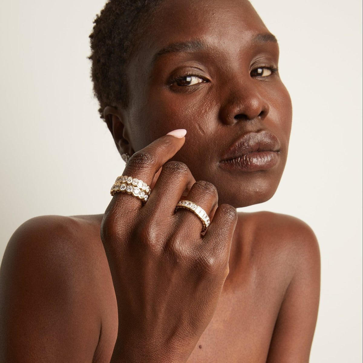 Model. woman wearing multiple diamond rings 