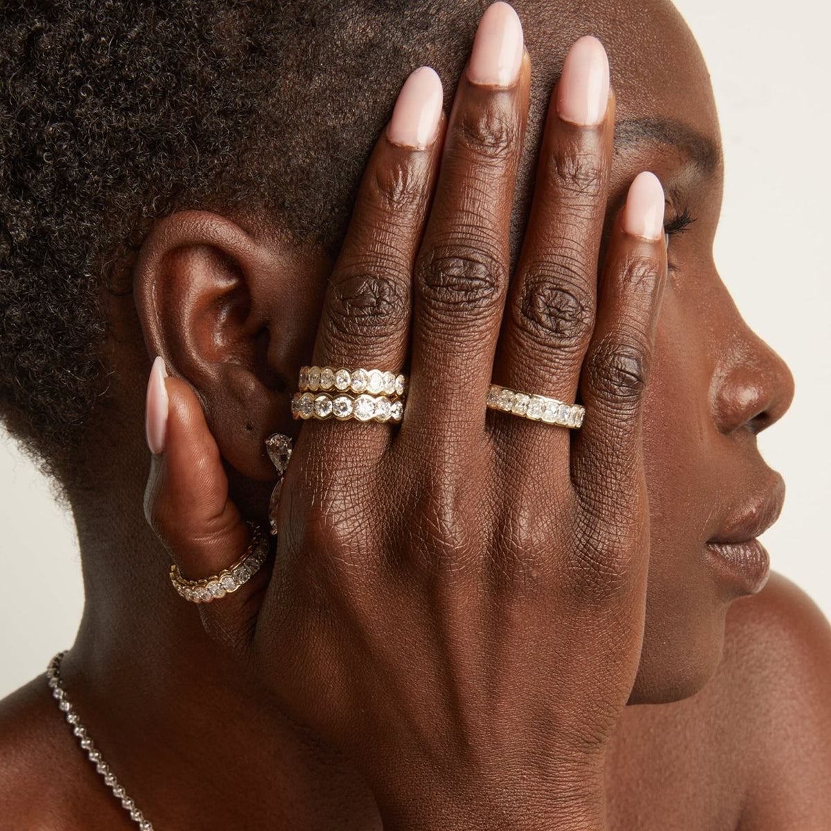 Model woman wearing multiple diamond rings 
