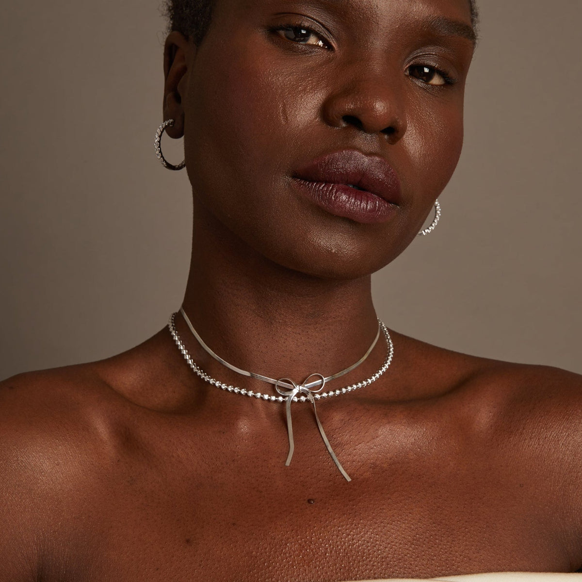 Model woman wearing two necklaces 