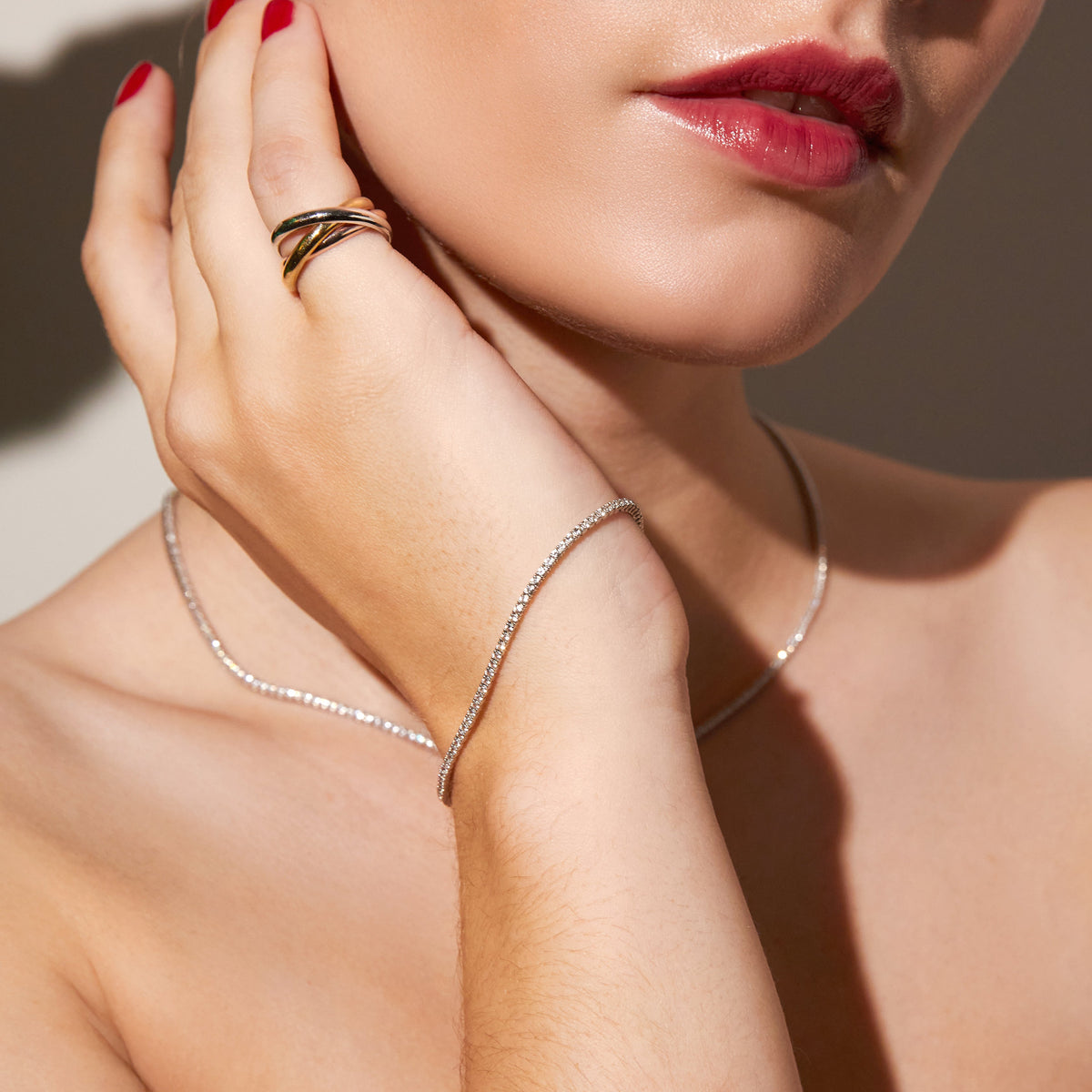 Model.  close up of woman wearing thin tennis bracelet 