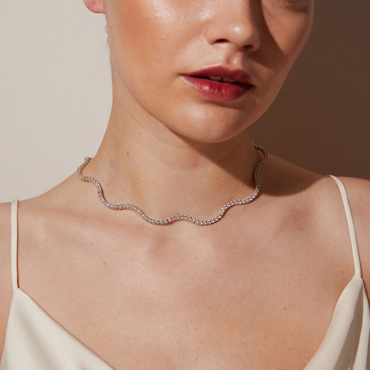 Model.  woman wearing wavy necklace 