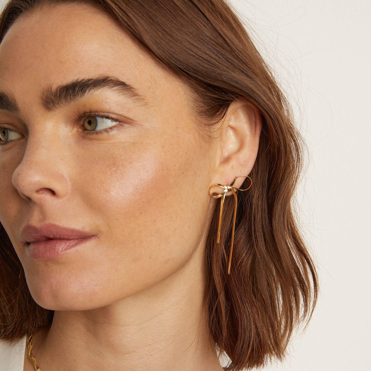 Model. Woman wearing bow earring 