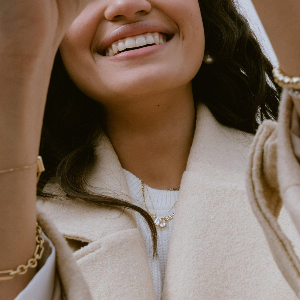 Lifestyle Model. Close of up woman wearing stacked necklaces.