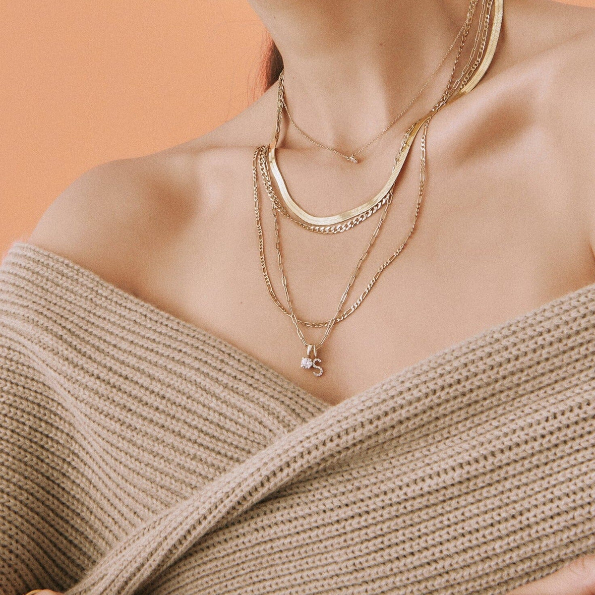 Lifestyle Model woman wearing various gold chains 