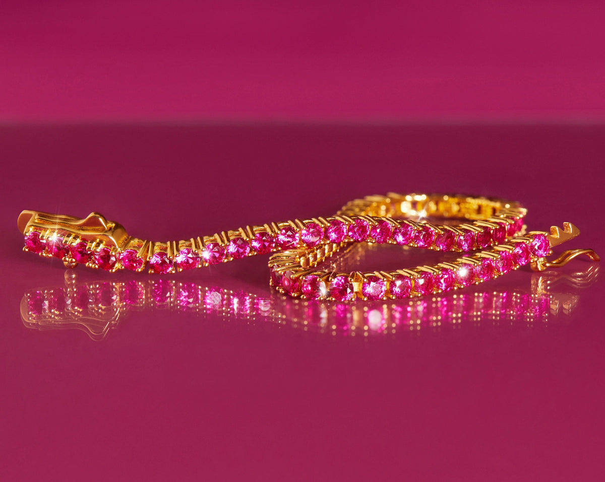 Flatlay Model close up of pink tennis bracelet on pink background 