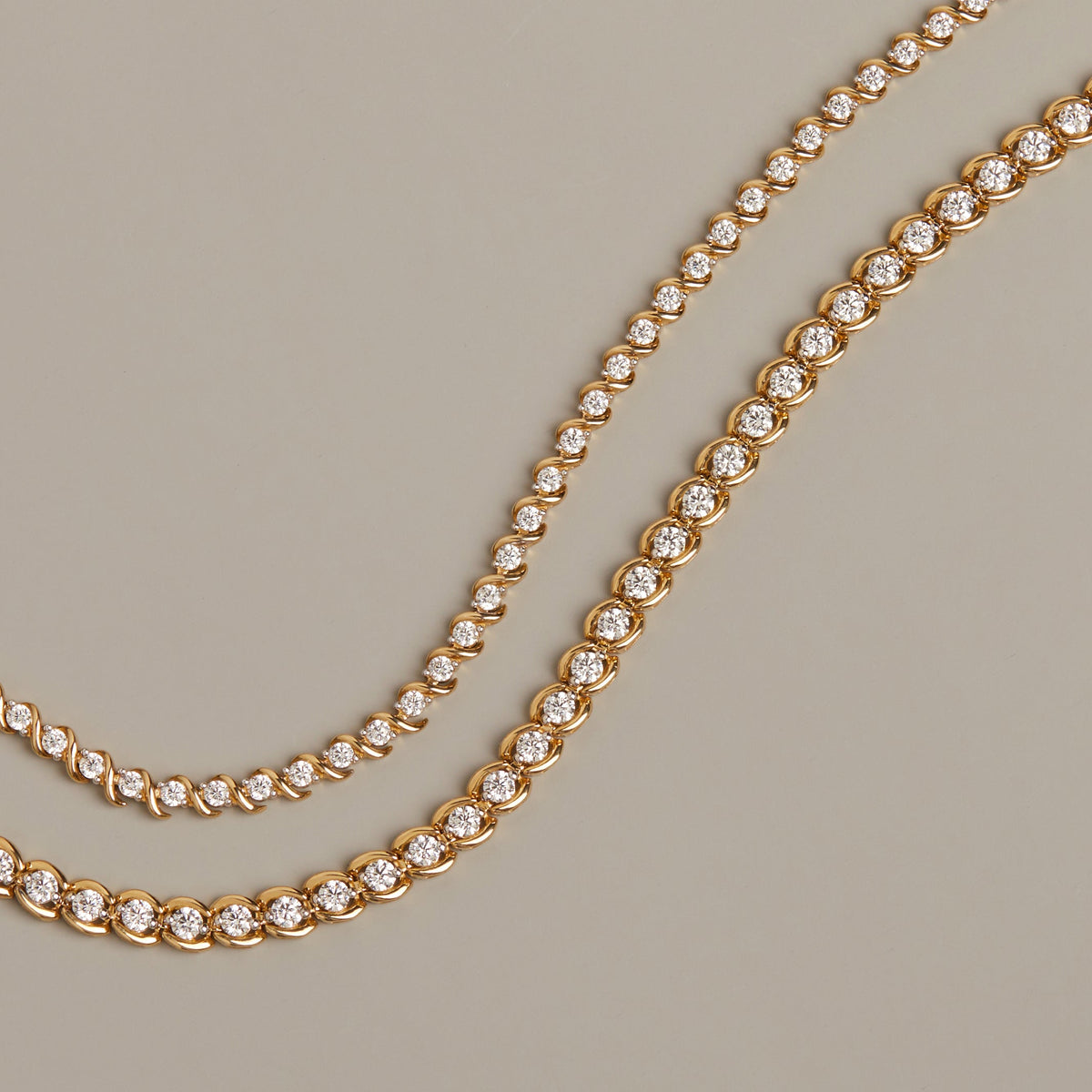 Flatlay Model. Gold necklace with diamonds on a beige background