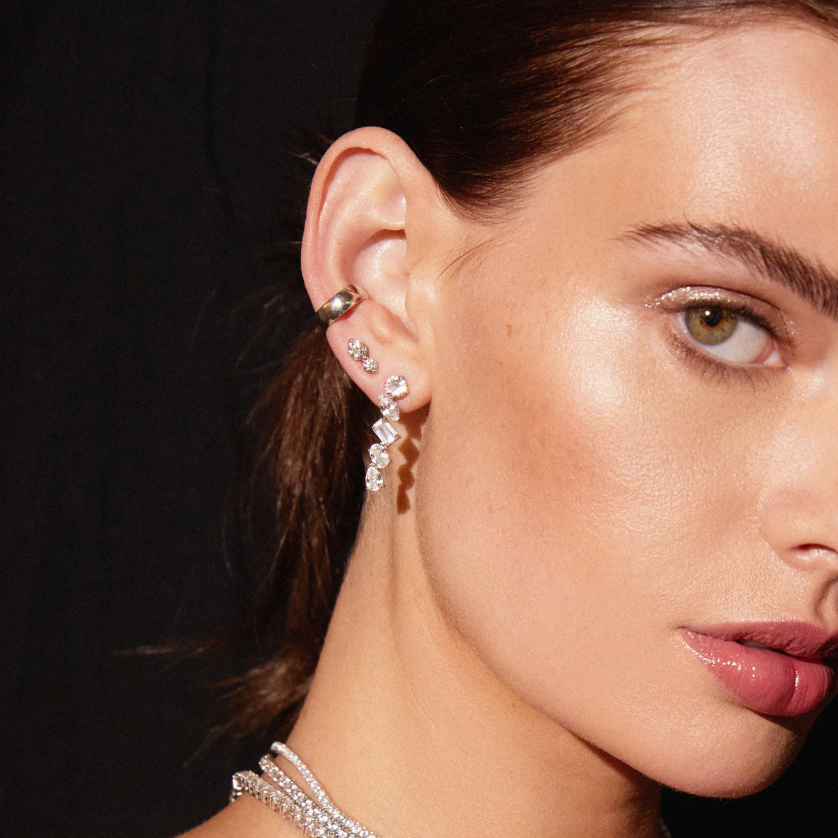 Model. Close up of woman wearing various earrings