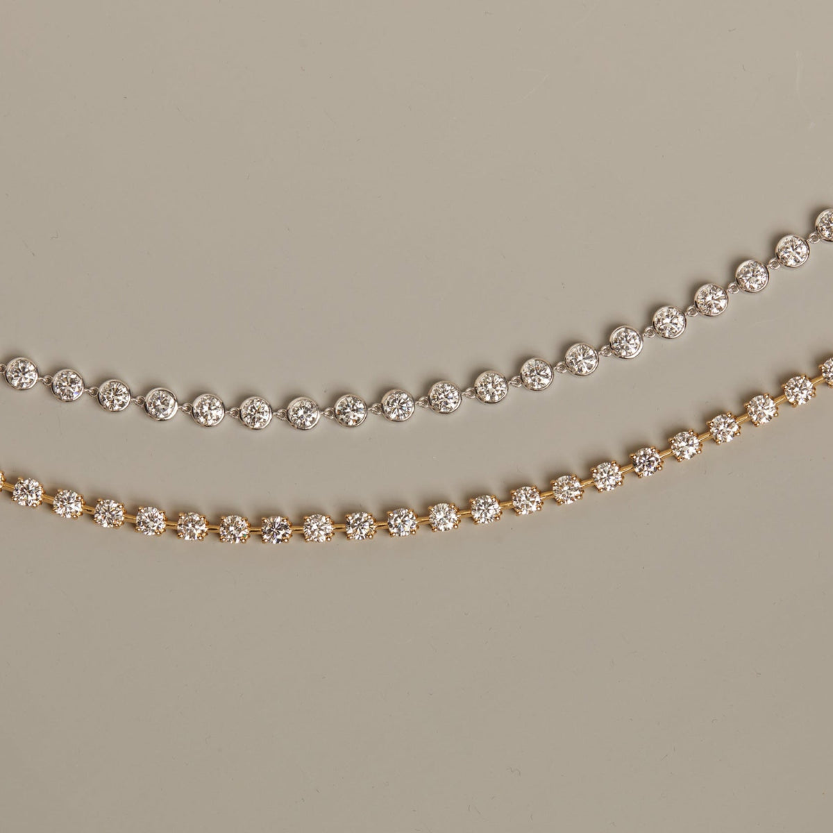 Model. Two diamond necklaces on a beige background