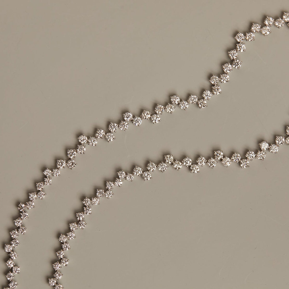 Model. Silver beaded chain on a beige background