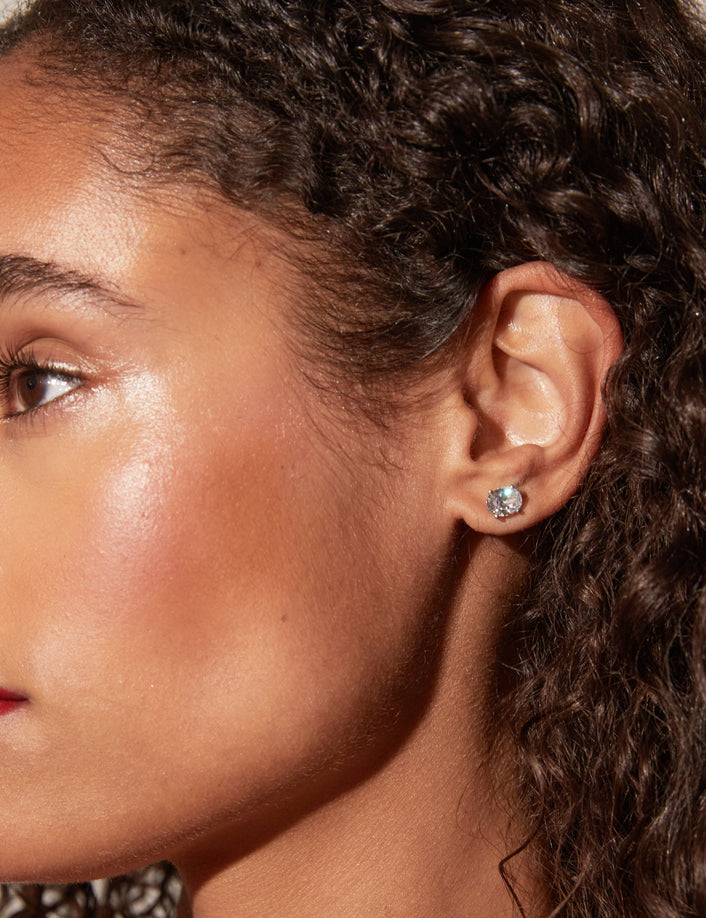 Model side profile of woman wearing diamond stud 